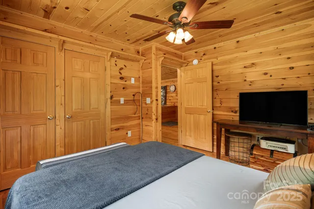 a patio with wooden floor a yard a table and chairs