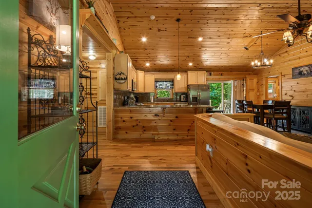 a living room with furniture kitchen view and a large window