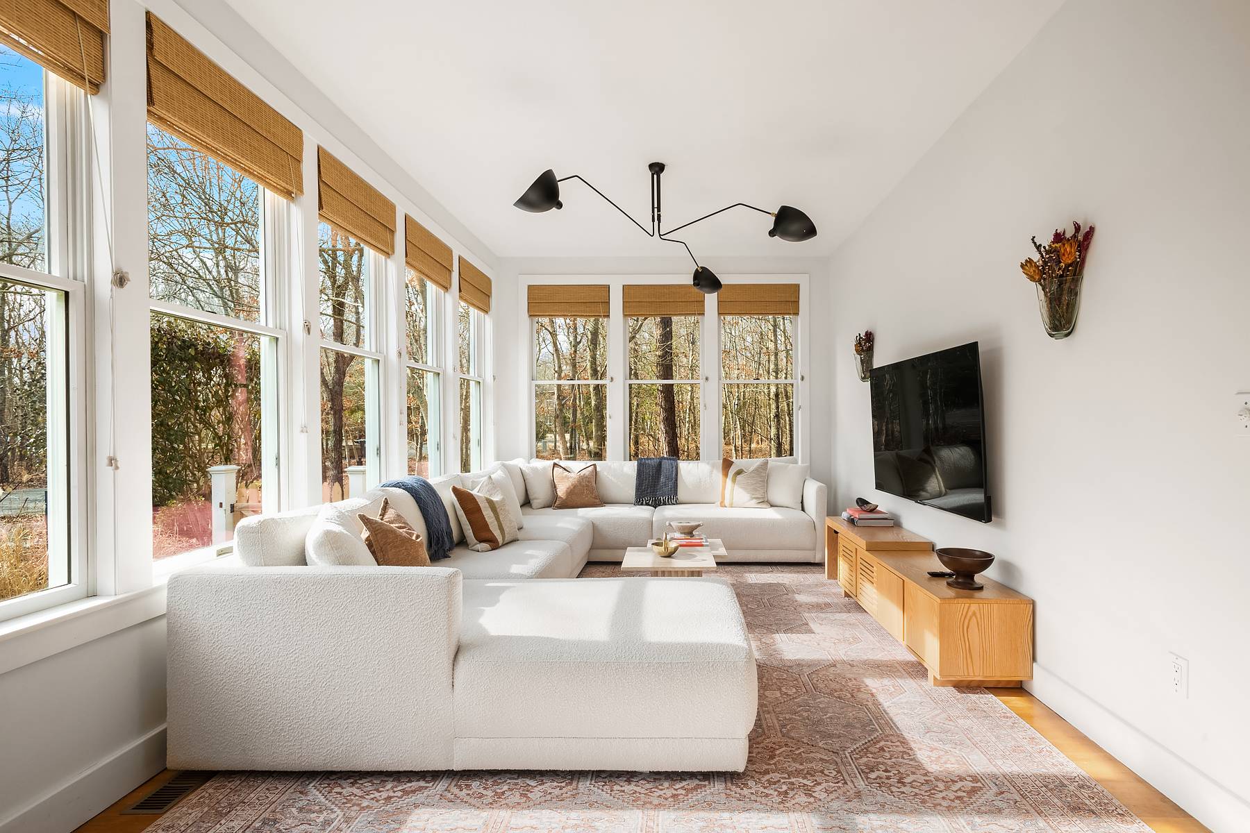 a living room with furniture and a flat screen tv