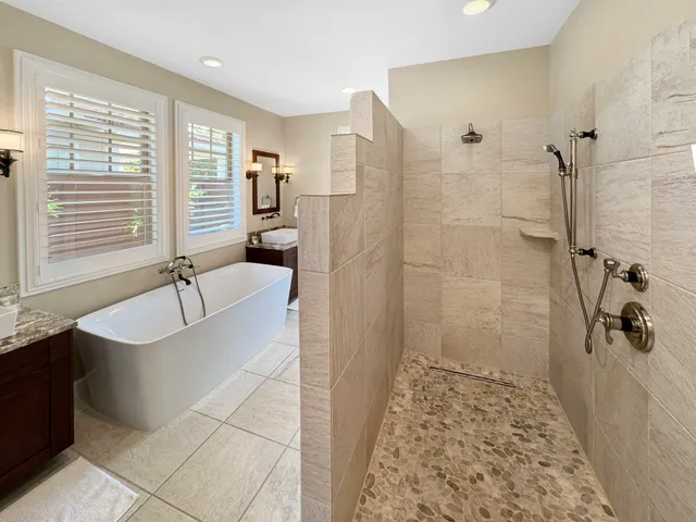 a bathroom with a bathtub and shower