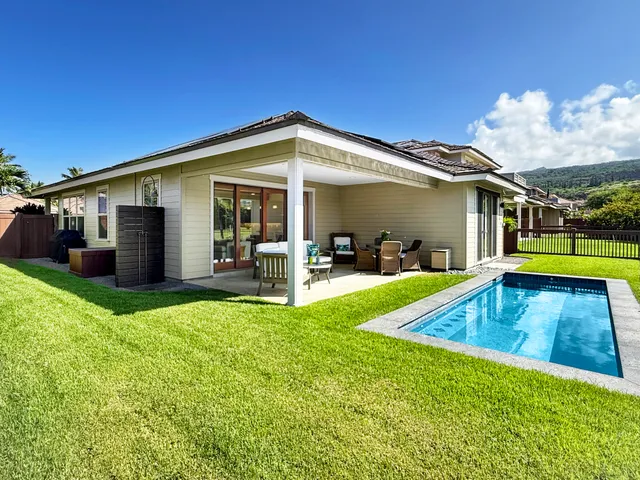 a view of a house with a backyard patio and swimming pool