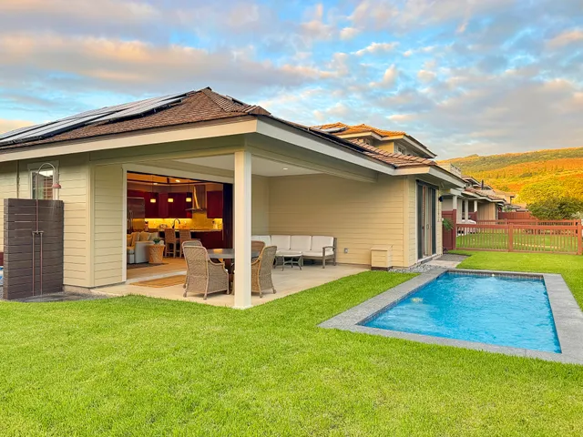 a view of a house with a yard and sitting area