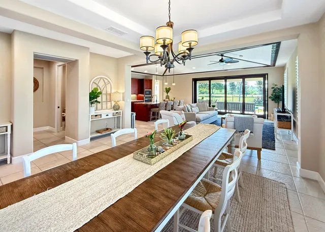 a view of a dining room with furniture a chandelier and wooden floor