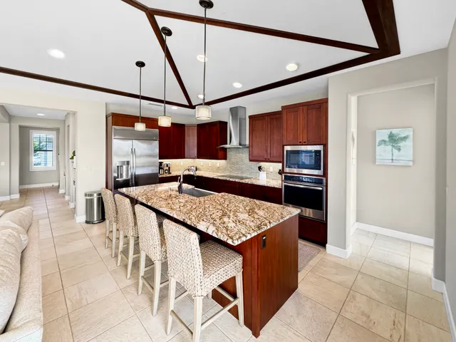 a kitchen with stainless steel appliances granite countertop a sink and cabinets