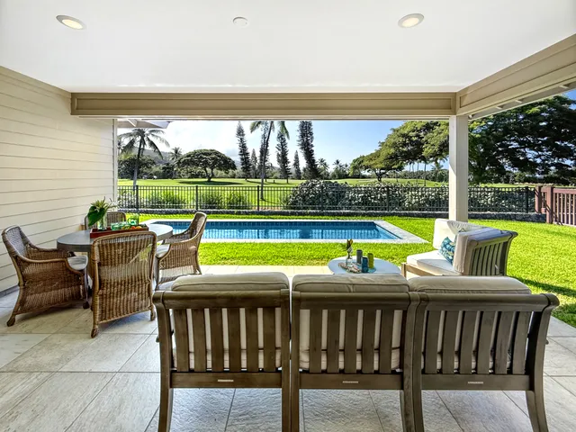 a view of a patio with swimming pool and furniture