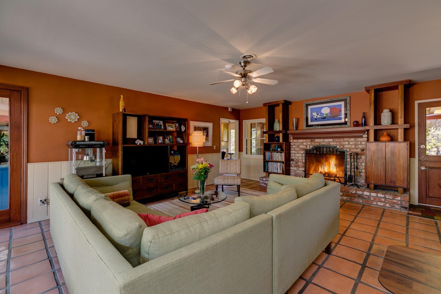 918 El Toro Road Ojai, CA 93023 - Photo 13 of 43 a living room with furniture a fireplace and a flat screen tv