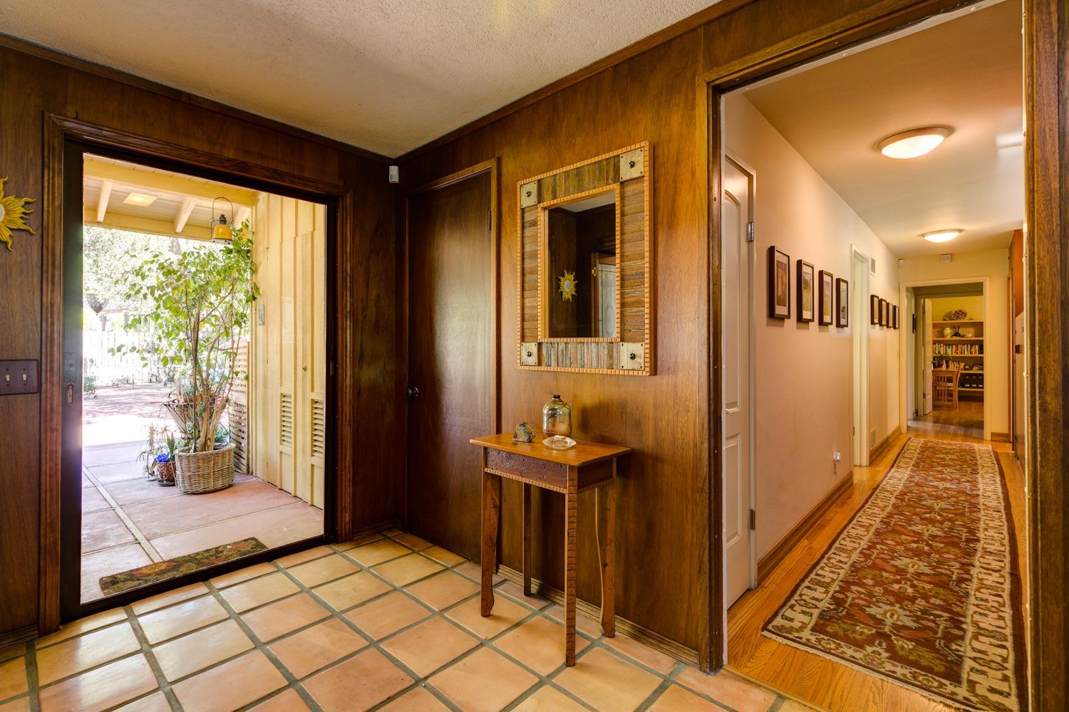918 El Toro Road Ojai, CA 93023 - Photo 17 of 43 a view of a hallway with wooden floor and a livingroom