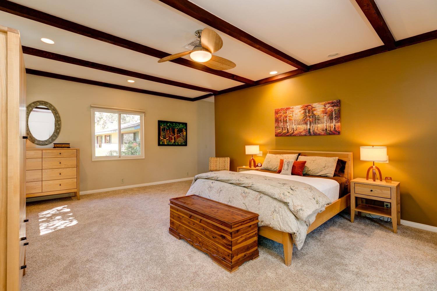 918 El Toro Road Ojai, CA 93023 - Photo 18 of 43 a bedroom with a bed a dresser and paintings on the wall