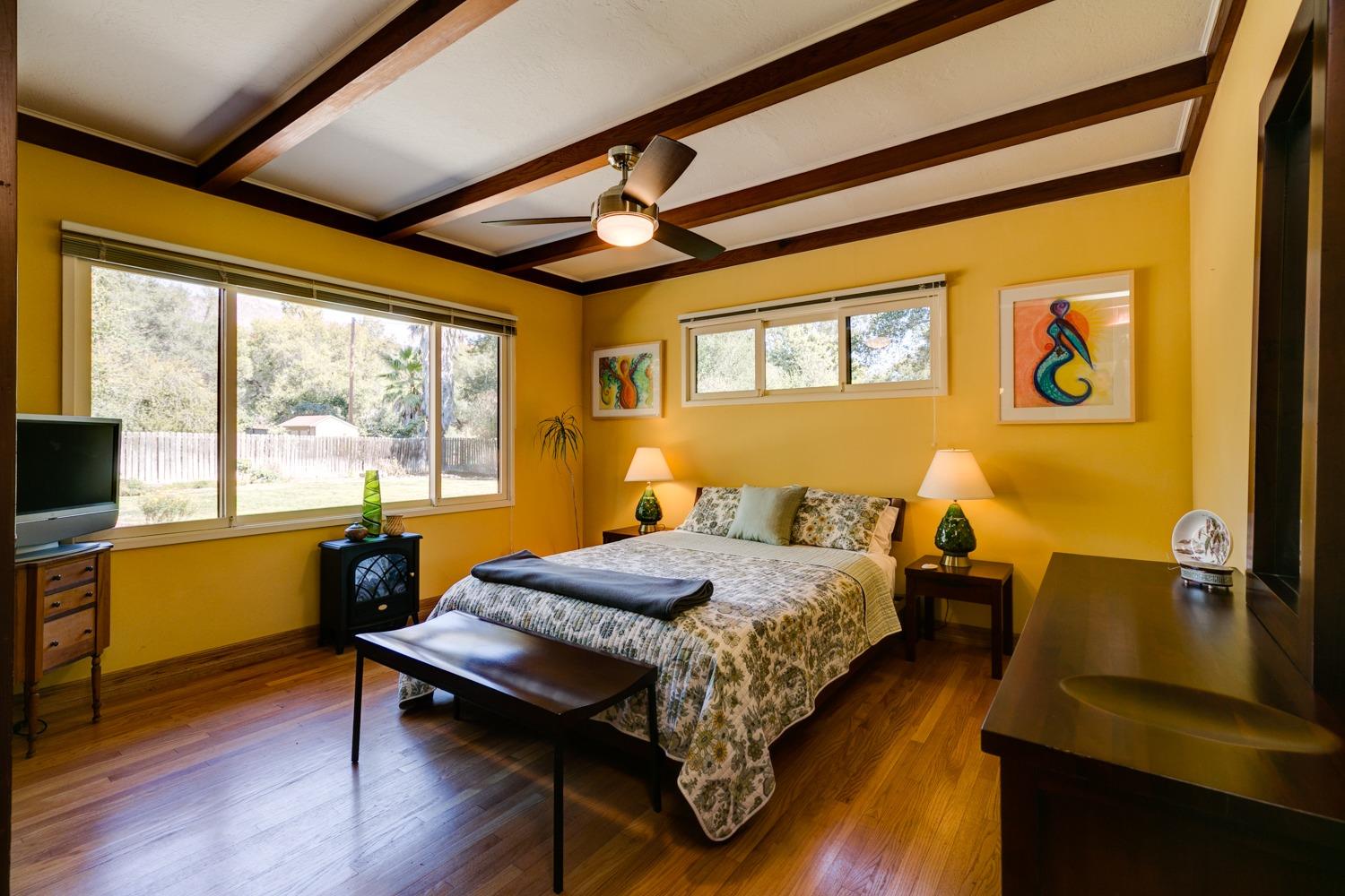 918 El Toro Road Ojai, CA 93023 - Photo 22 of 43 a bedroom with a bed and wooden floor