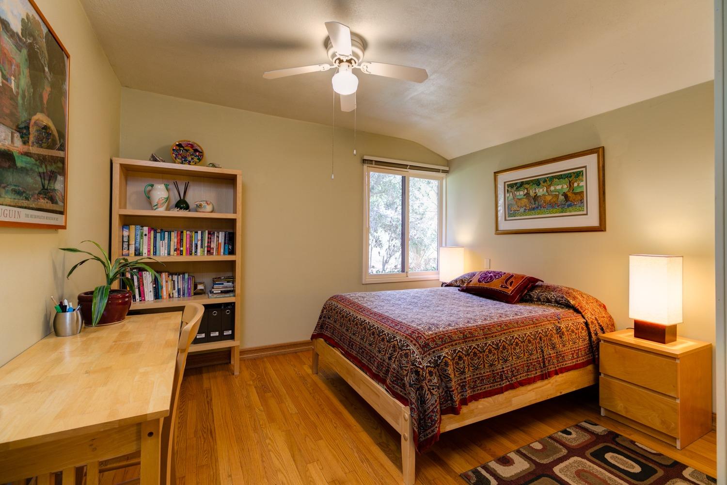 918 El Toro Road Ojai, CA 93023 - Photo 24 of 43 a bedroom with a bed and a bookshelf with the bookshelf