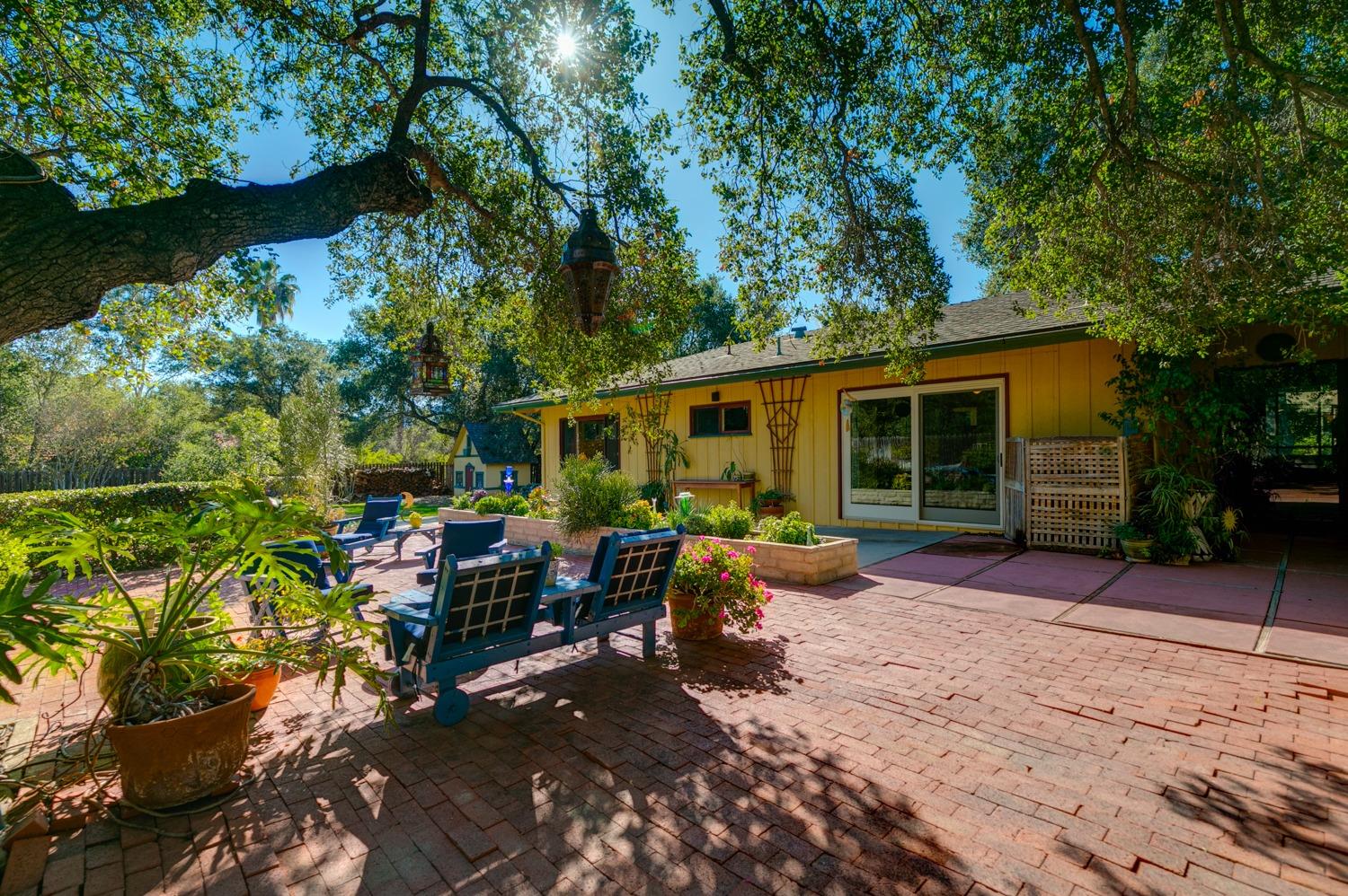 918 El Toro Road Ojai, CA 93023 - Photo 34 of 43 a view of a patio with table and chairs potted plants and large tree