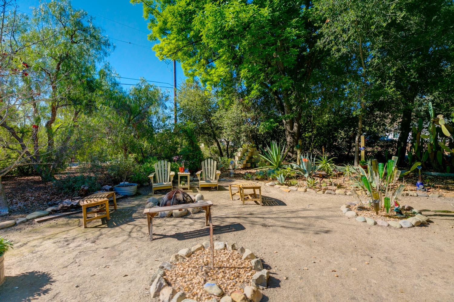 918 El Toro Road Ojai, CA 93023 - Photo 35 of 43 a view of a backyard with a fire pit and a large tree