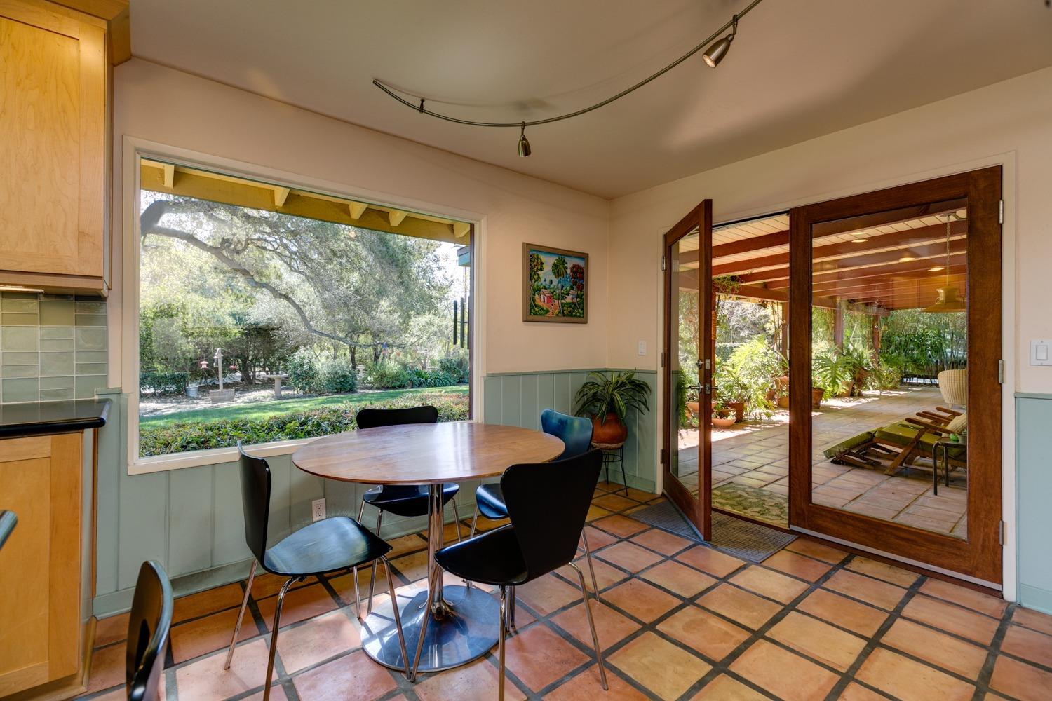 918 El Toro Road Ojai, CA 93023 - Photo 9 of 43 a view of a dining room with furniture wooden floor and a floor to ceiling window
