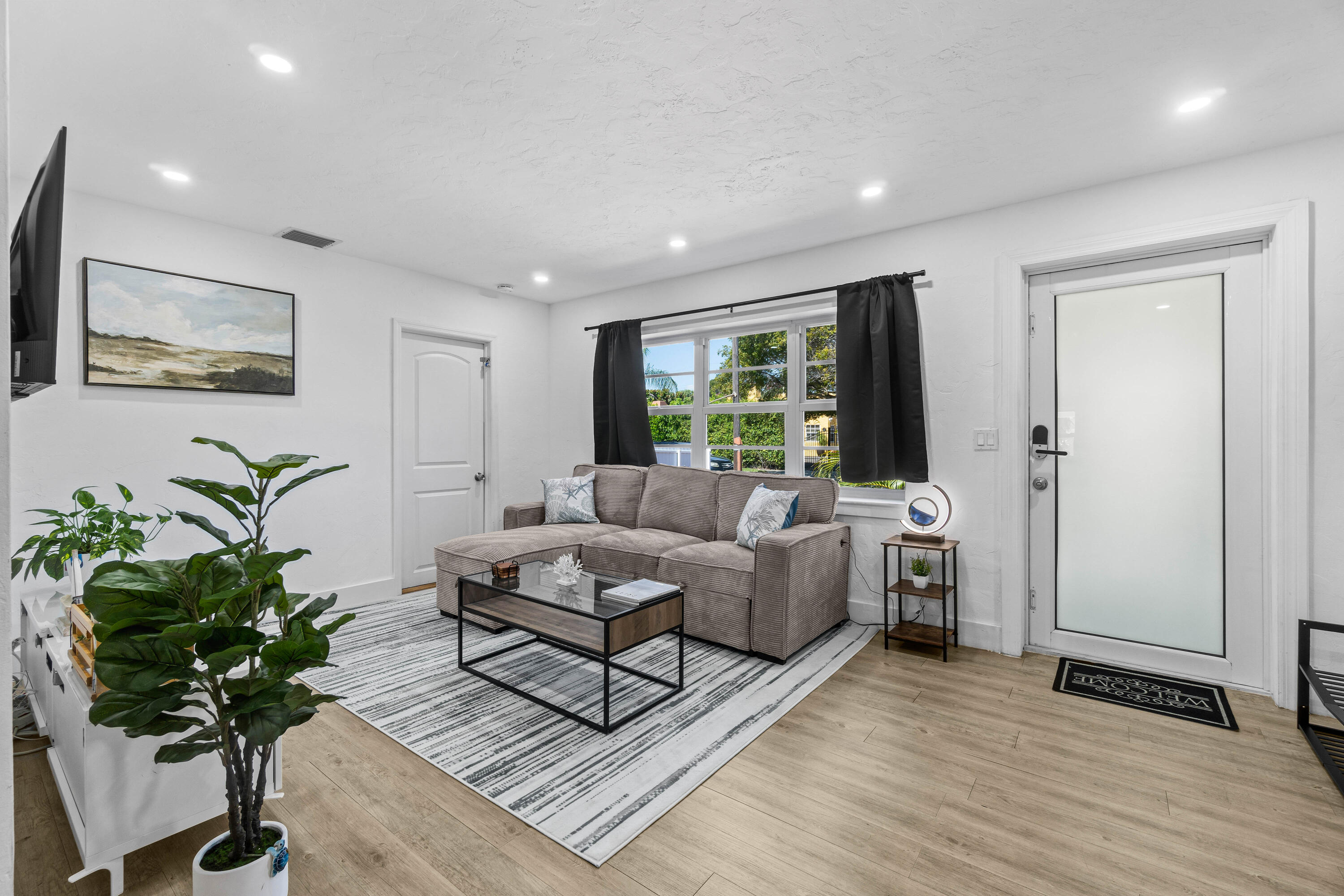 814 Franklin Road West Palm Beach, FL 33405 - Photo 1 of 12 a living room with furniture potted plant and a window