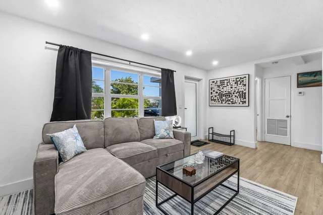 a living room with furniture and a large window