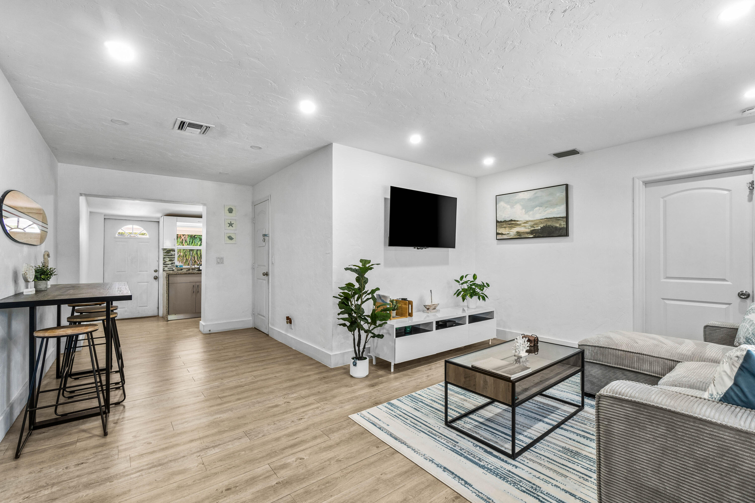 814 Franklin Road West Palm Beach, FL 33405 - Photo 3 of 12 a living room with furniture and a flat screen tv