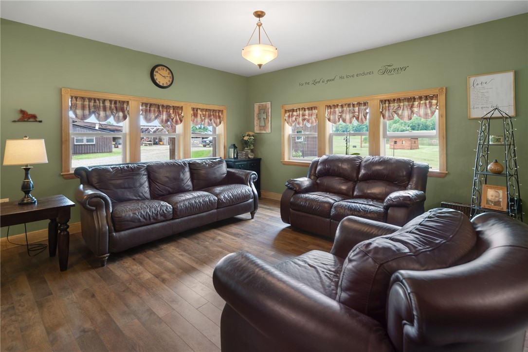 5903 Howell Road Locke, NY 13092 - Photo 7 of 44 Inviting living room with expansive windows overlooking your private 3/4 acre pond