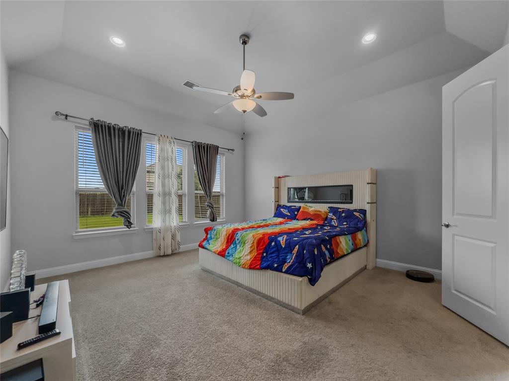 116 Chaco Drive Forney, TX 75126 - Photo 21 of 27 a bedroom with a bed mirror and window