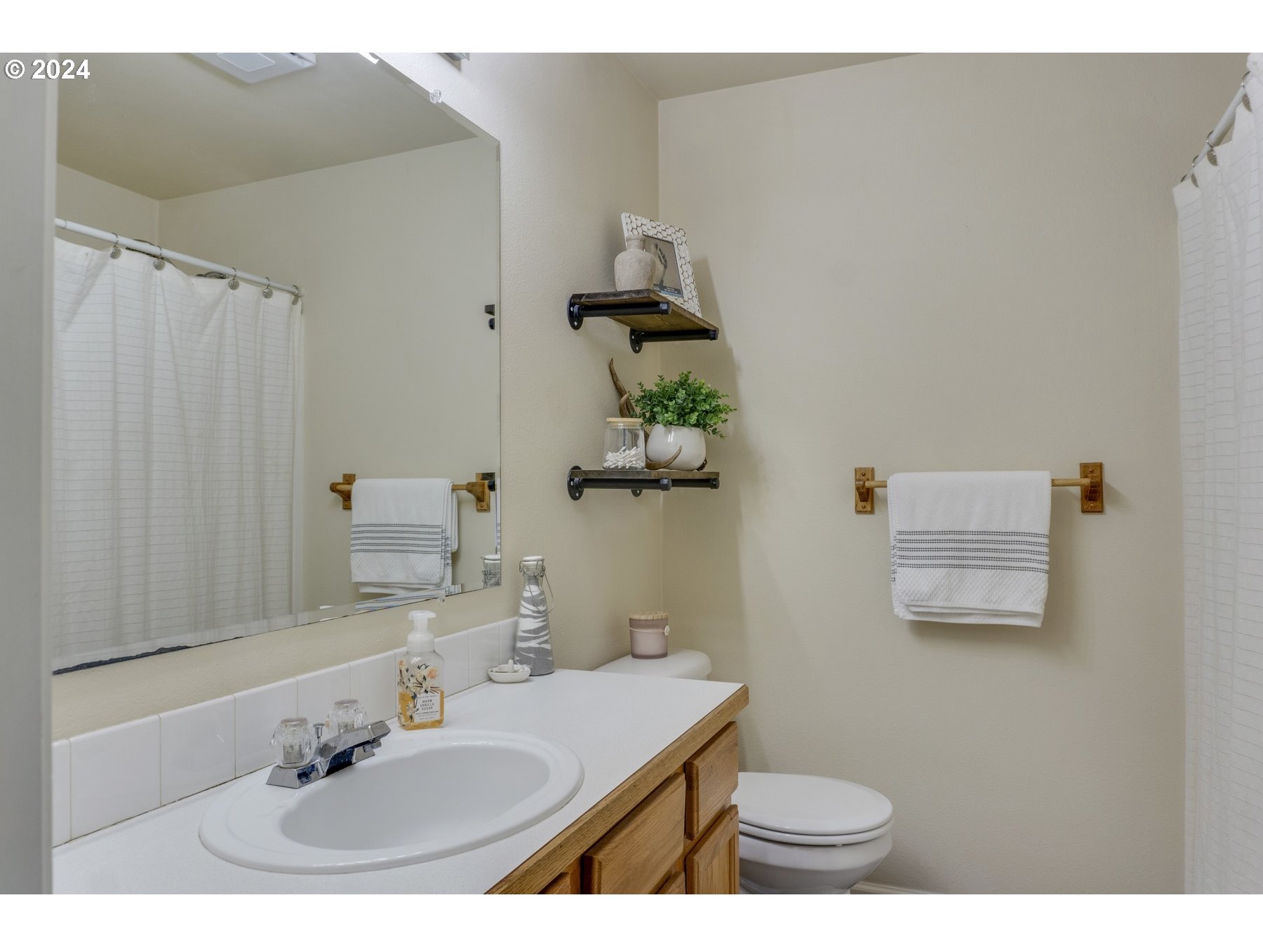 3311 Pinyon Street Springfield, OR 97478 - Photo 17 of 21 a bathroom with a sink toilet and mirror