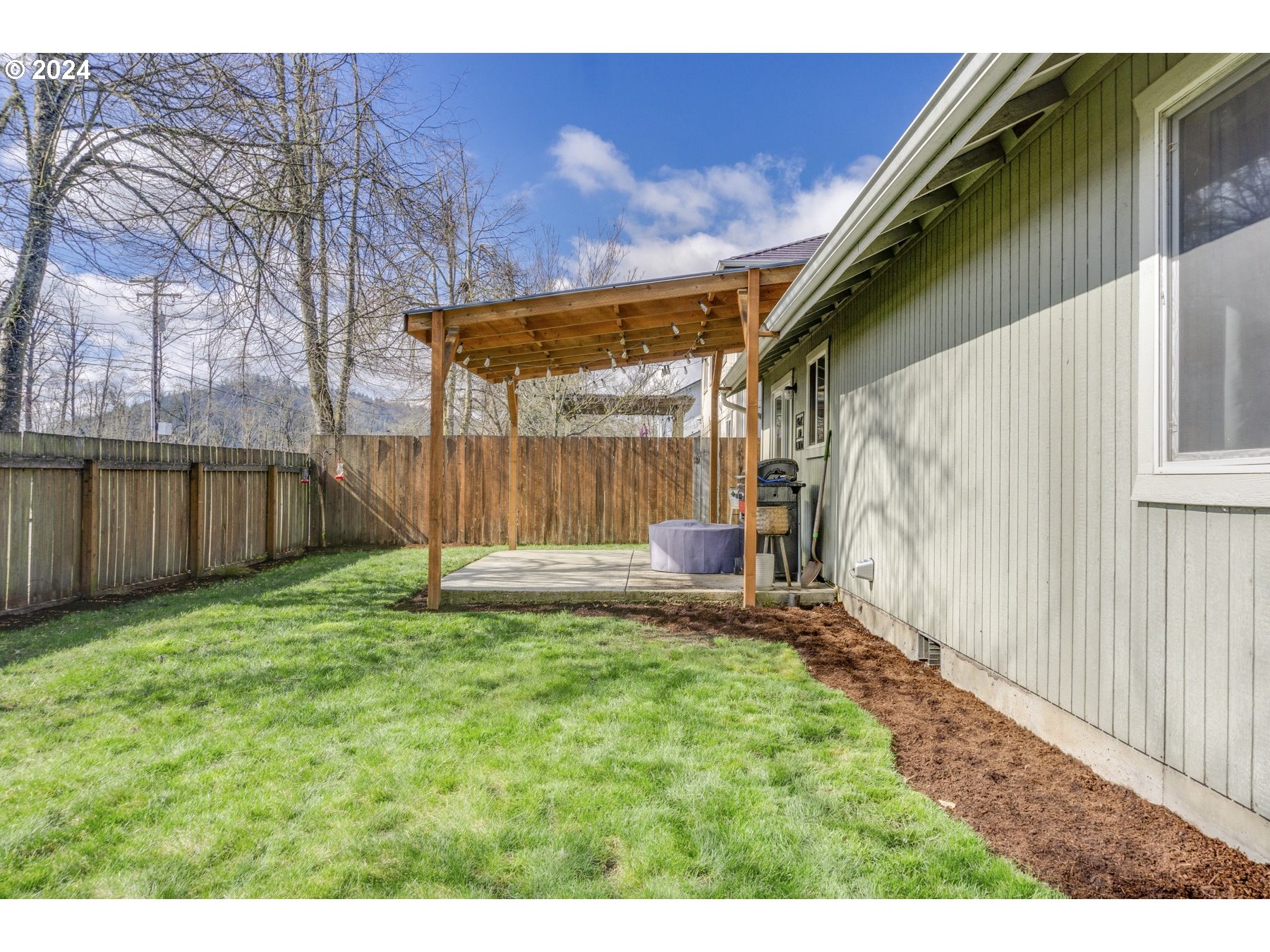 3311 Pinyon Street Springfield, OR 97478 - Photo 18 of 21 a view of backyard with table and chairs and wooden fence