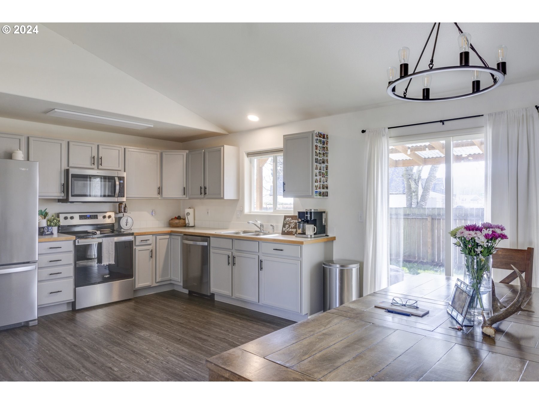 3311 Pinyon Street Springfield, OR 97478 - Photo 7 of 21 a kitchen with stainless steel appliances granite countertop a stove refrigerator and cabinets