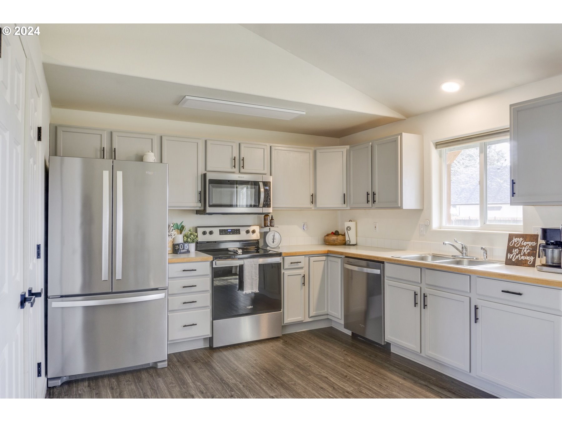 3311 Pinyon Street Springfield, OR 97478 - Photo 8 of 21 a kitchen with stainless steel appliances a sink cabinets and a refrigerator