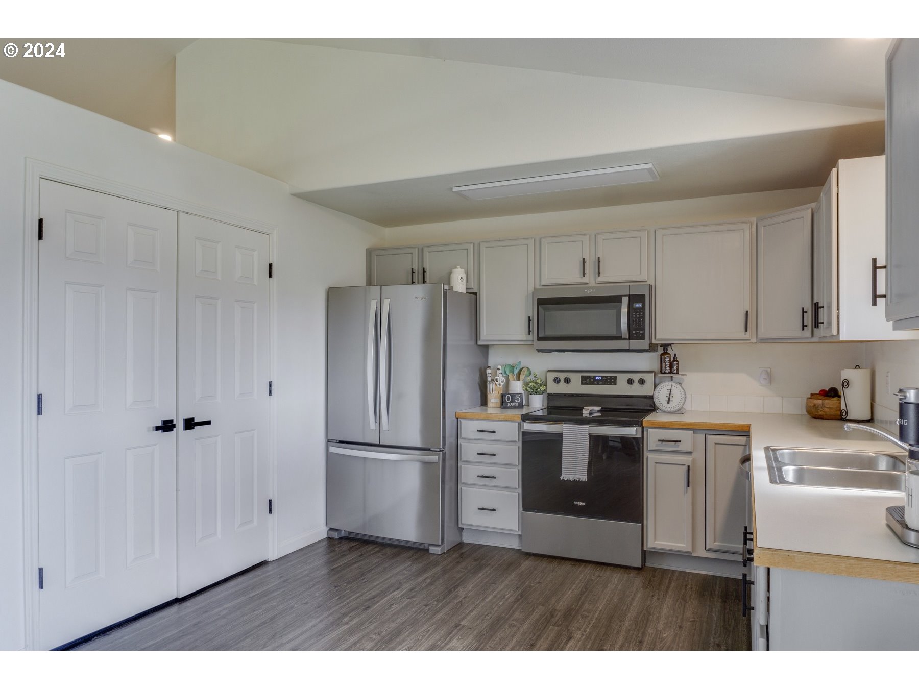 3311 Pinyon Street Springfield, OR 97478 - Photo 9 of 21 a kitchen with stainless steel appliances granite countertop a refrigerator a stove a sink and white cabinets