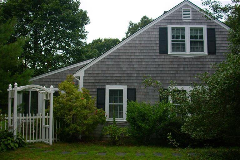 67 Joyce Anne Road Centerville, MA 02632 - Photo 4 of 32 a front view of a house with a yard