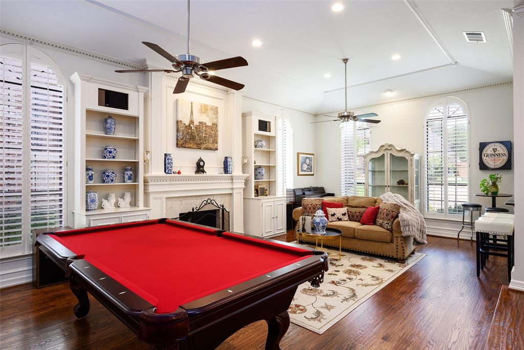 6822 Meadow Road Dallas, TX 75230 - Photo 17 of 35 Spacious room Living Room with plantation shutters, handscraped wood floors, Italian marble surround fire place, high ceilings.