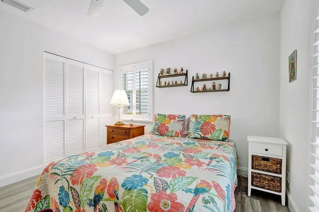 a bedroom with a bed and ceiling fan