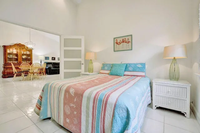 a spacious bathroom with a granite countertop sink a mirror and shower