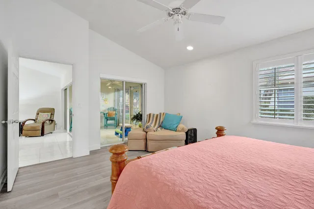 a sign of golf club on a wall under a large tree