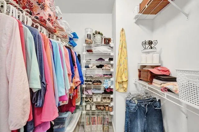 a living room with furniture chandelier and a large window