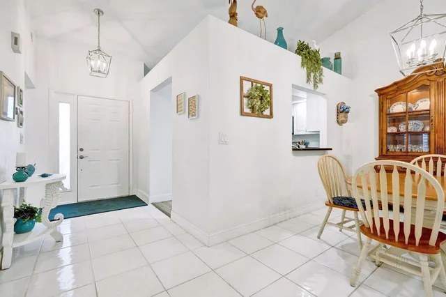 a kitchen with a refrigerator and white cabinets