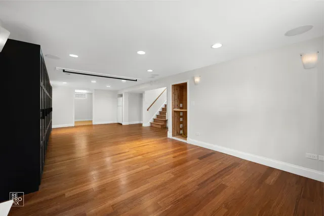 a view of empty room with wooden floor