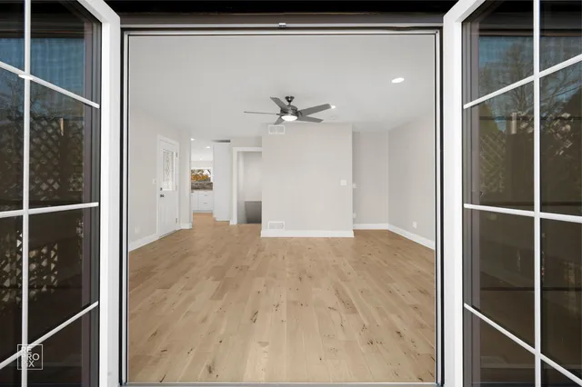 a view of a hallway with a ceiling fan