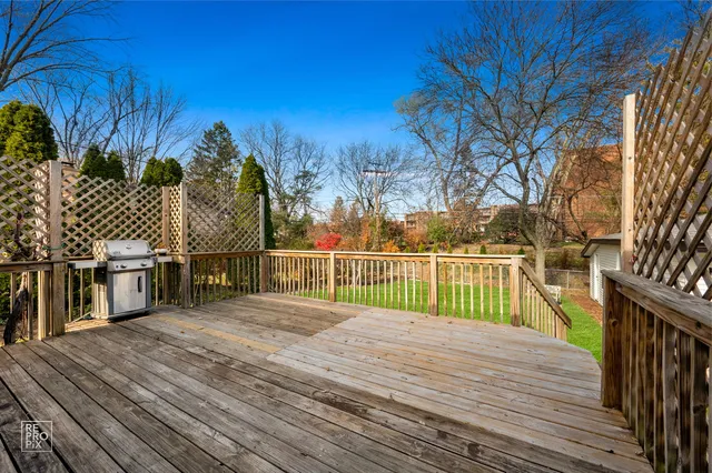 a view of a balcony with wooden floor and fence