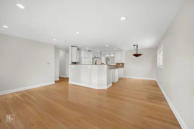 a view of kitchen and hall with wooden floor