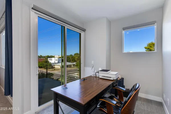 a view of a workspace with a table and chairs in kitchen