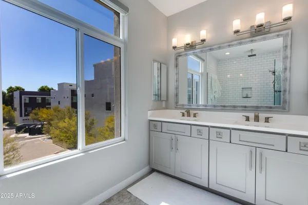 a bathroom with a sink double vanity and a mirror