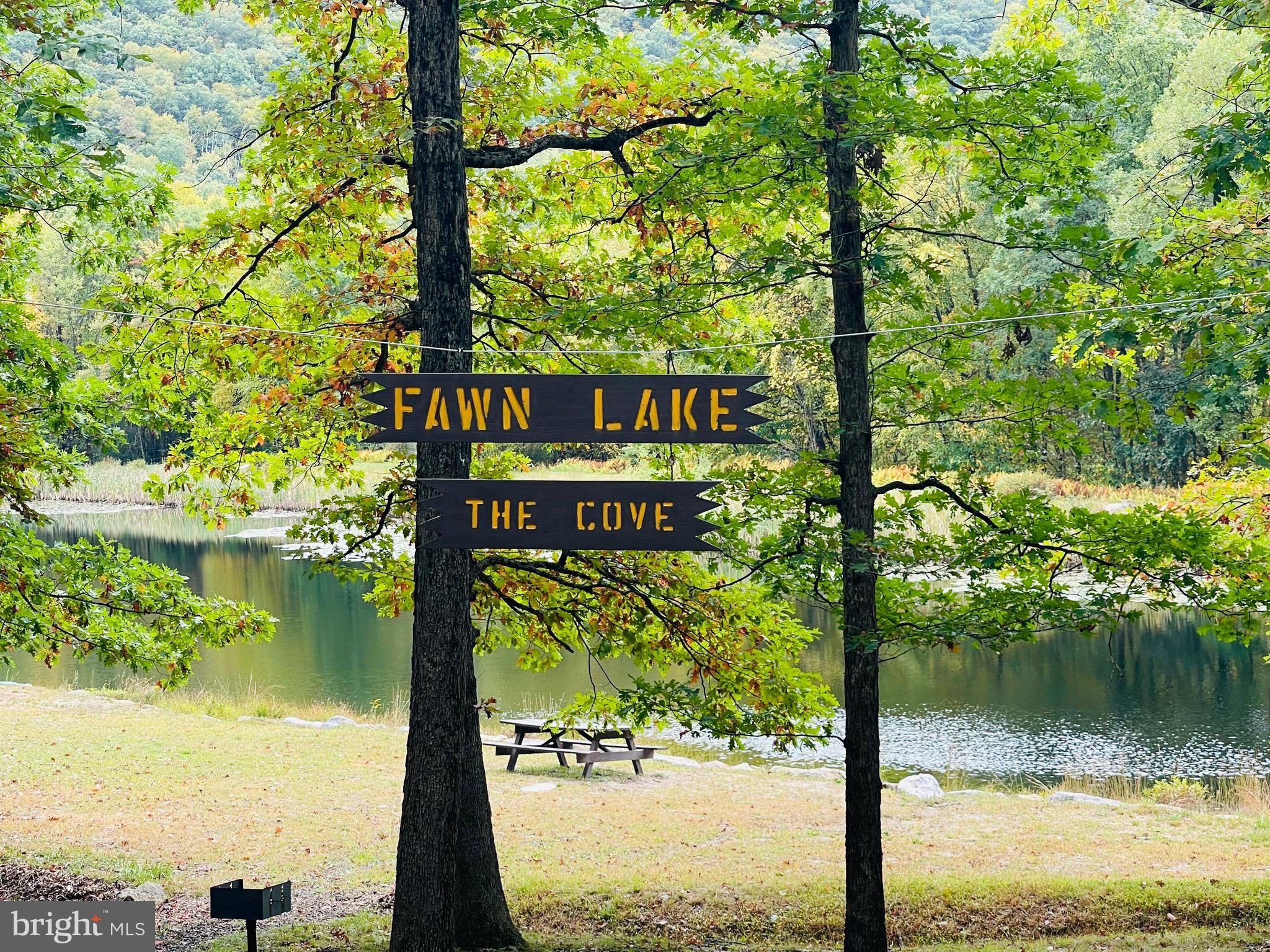 124 Spring Mountain Drive Zion Grove, PA 17985 - Photo 8 of 18 a sign that is sitting in front of a lake