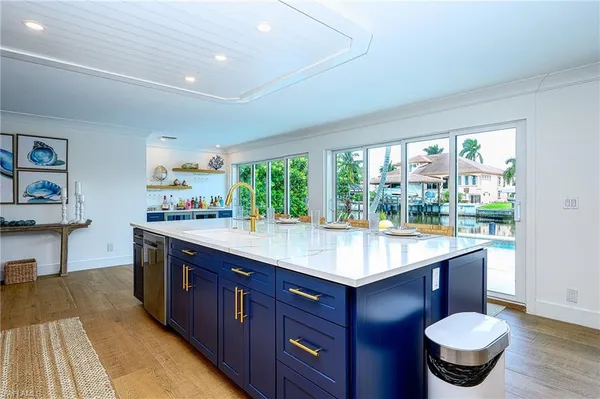 a kitchen with stainless steel appliances granite countertop sink stove and wooden cabinets