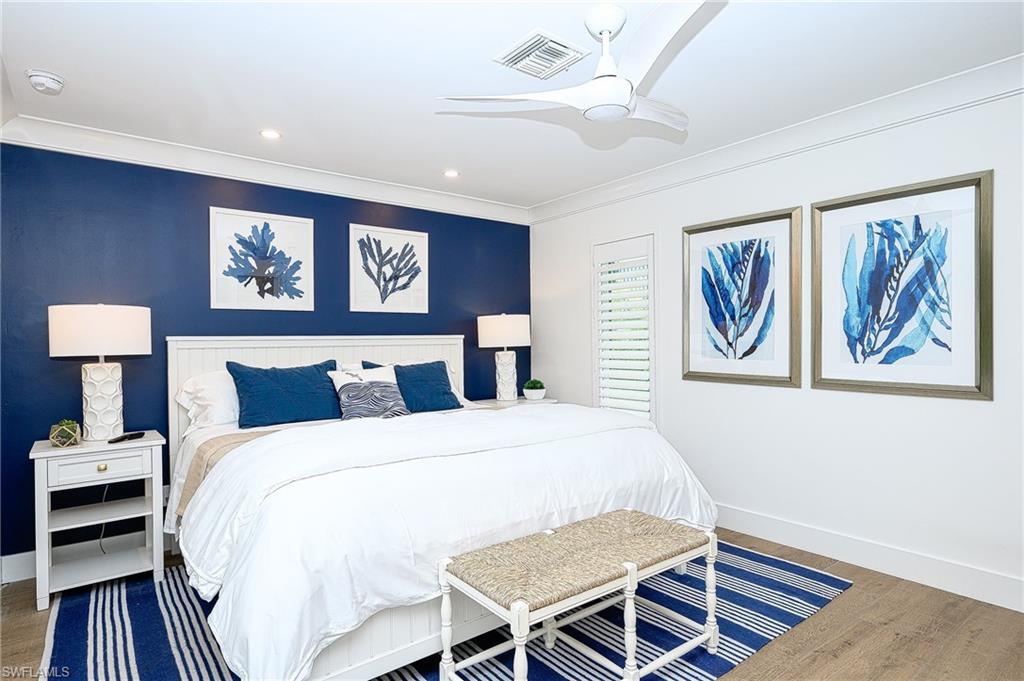 343 Conners Avenue Naples, FL 34108 - Photo 17 of 34 a bedroom with a bed and a table