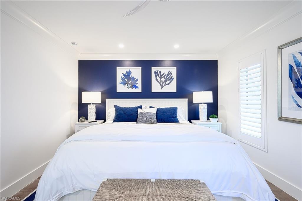 343 Conners Avenue Naples, FL 34108 - Photo 18 of 34 a bedroom with a bed and a window