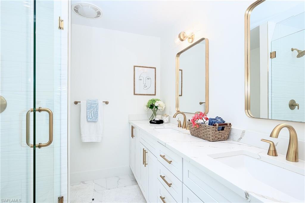 343 Conners Avenue Naples, FL 34108 - Photo 20 of 34 a bathroom with a double vanity sink mirror and shower