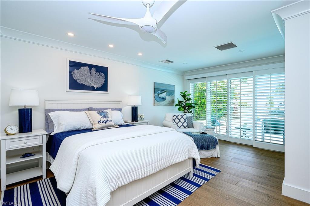 343 Conners Avenue Naples, FL 34108 - Photo 21 of 34 a bedroom with a large bed and a large window