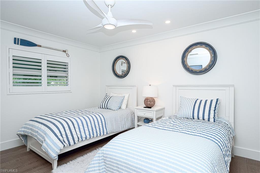 343 Conners Avenue Naples, FL 34108 - Photo 24 of 34 a bedroom with bed and a lamp