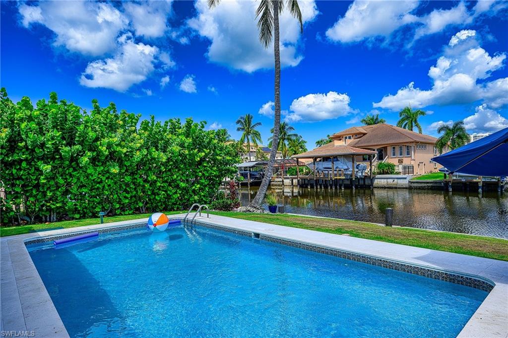 343 Conners Avenue Naples, FL 34108 - Photo 27 of 34 a view of a lake with a house