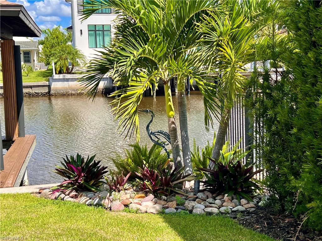 343 Conners Avenue Naples, FL 34108 - Photo 28 of 34 a view of a backyard of a house with a lake view