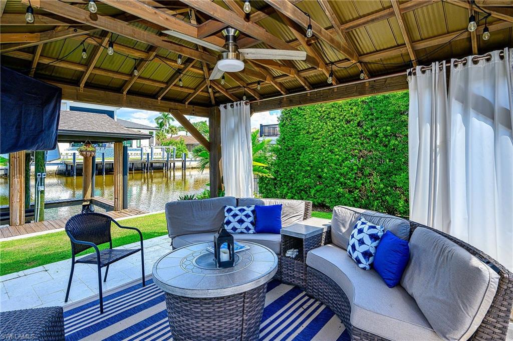 343 Conners Avenue Naples, FL 34108 - Photo 29 of 34 a outdoor living space with furniture and garden view